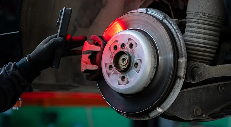 Mechanic explaining brake repair cost and brake inspection in Naples FL